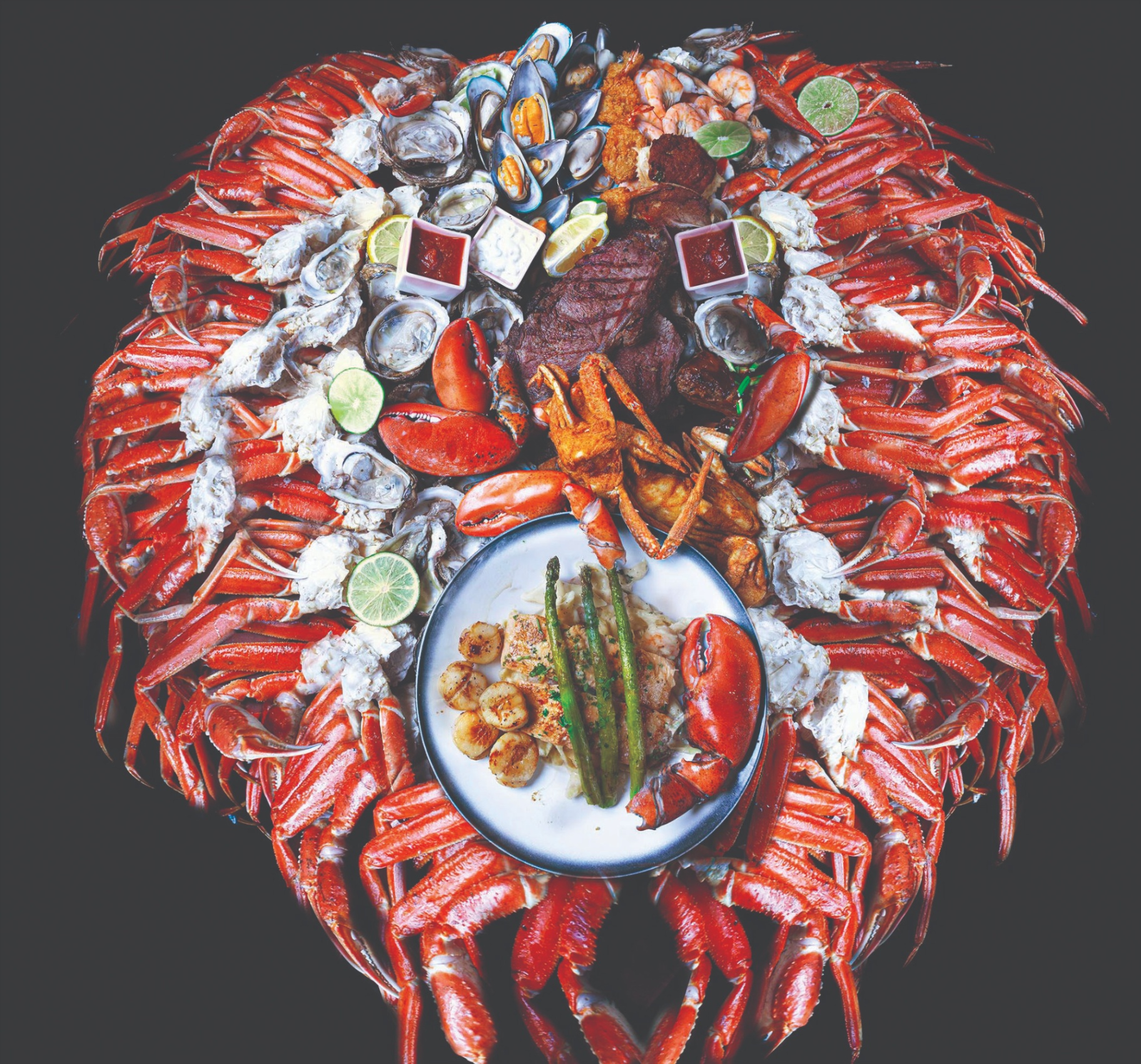 The HOOKS signature seafood tower — snow crab legs, oysters, mussels, lobster and prime rib